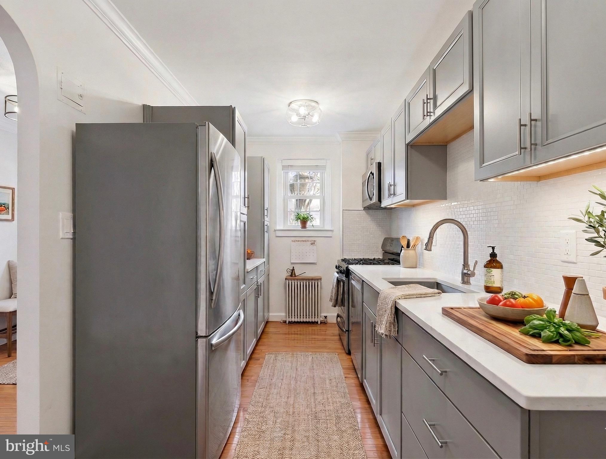 3925 Davis Place Northwest, Unit 206 Washington, DC 20007 - Photo 2 of 26 a kitchen with stainless steel appliances granite countertop a refrigerator and a stove top oven