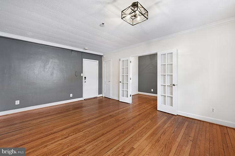 3925 Davis Place Northwest, Unit 206 Washington, DC 20007 - Photo 6 of 26 a view of an empty room with wooden floor