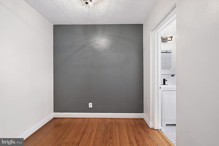 3925 Davis Place Northwest, Unit 206 Washington, DC 20007 - Photo 9 of 26 an empty room with wooden floor and closet