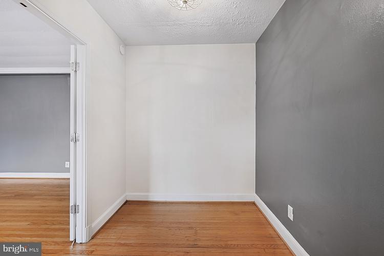 3925 Davis Place Northwest, Unit 206 Washington, DC 20007 - Photo 10 of 26 a view of an empty room with wooden floor