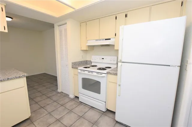 a kitchen with a refrigerator and a stove