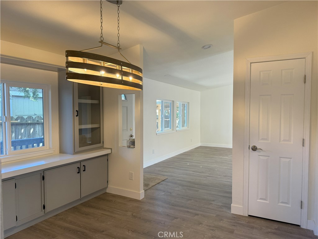 3835 Gardiner Ferry Road, Unit 98 Corning, CA 96021 - Photo 3 of 11 a view of an empty room with wooden floor and a window