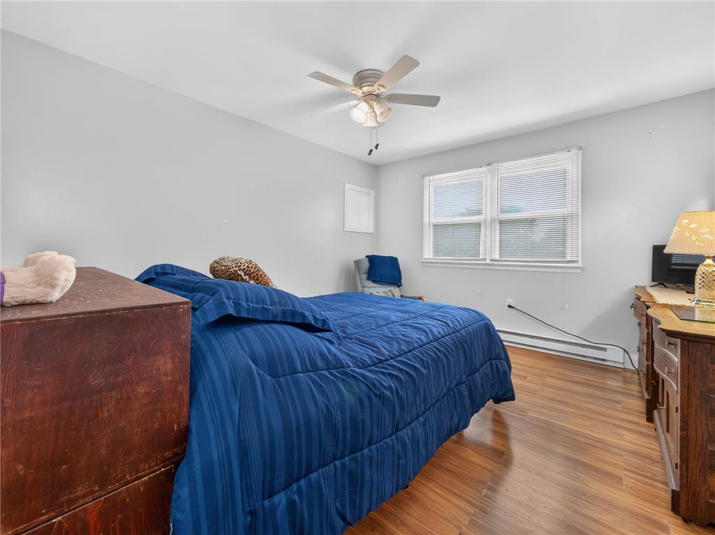3046 Ridon Court Bethlehem, PA 18020 - Photo 26 of 41 Hardwood flooring extends throughout this naturally illuminated bedroom with a modern ceiling fan and ample window light.