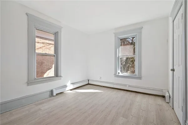a view of a room with wooden floor and a window