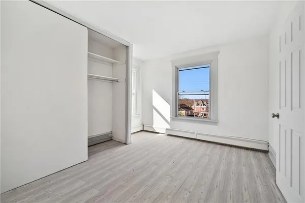 a view of an empty room and wooden floor