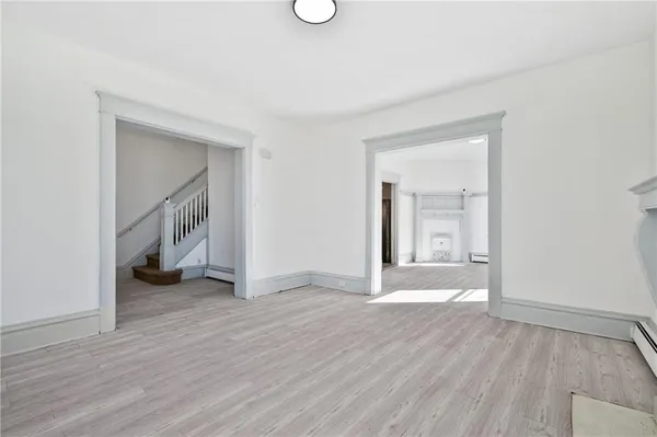 wooden floor in an empty room with a window