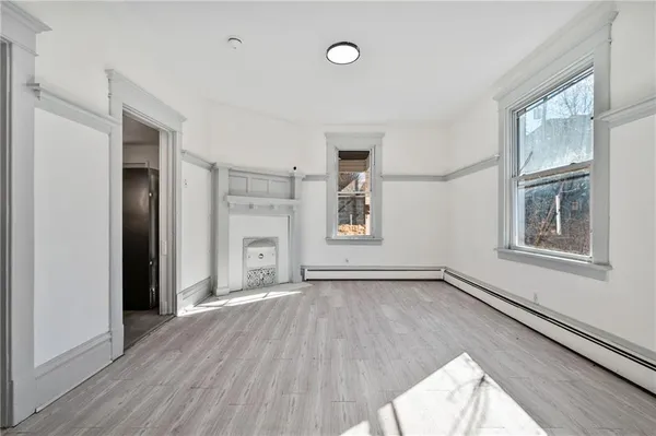 a view of a room with wooden floor and windows