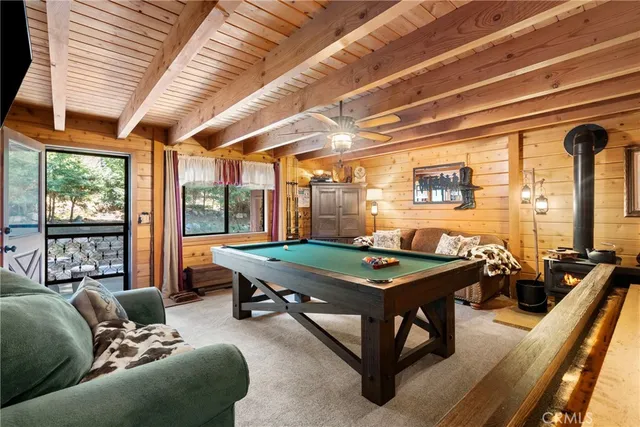 a living room with furniture a table and large windows