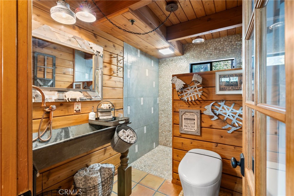 116 Pine Ridge Road Crestline, CA 92325 - Photo 15 of 35 a bathroom with a toilet sink and mirror