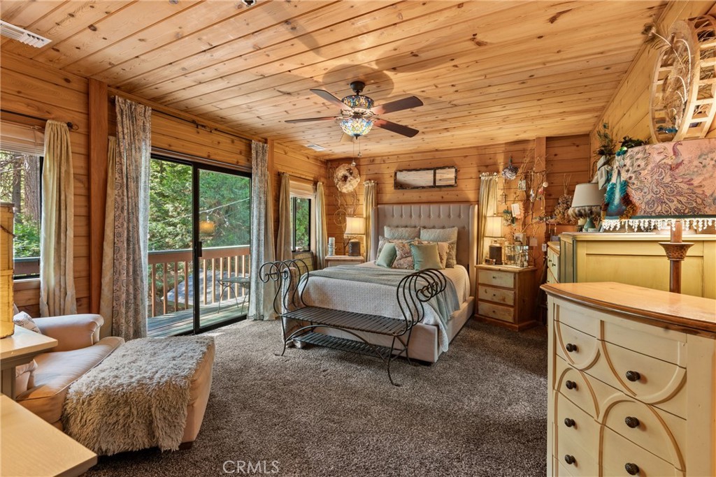 116 Pine Ridge Road Crestline, CA 92325 - Photo 18 of 35 a bedroom with furniture and large windows