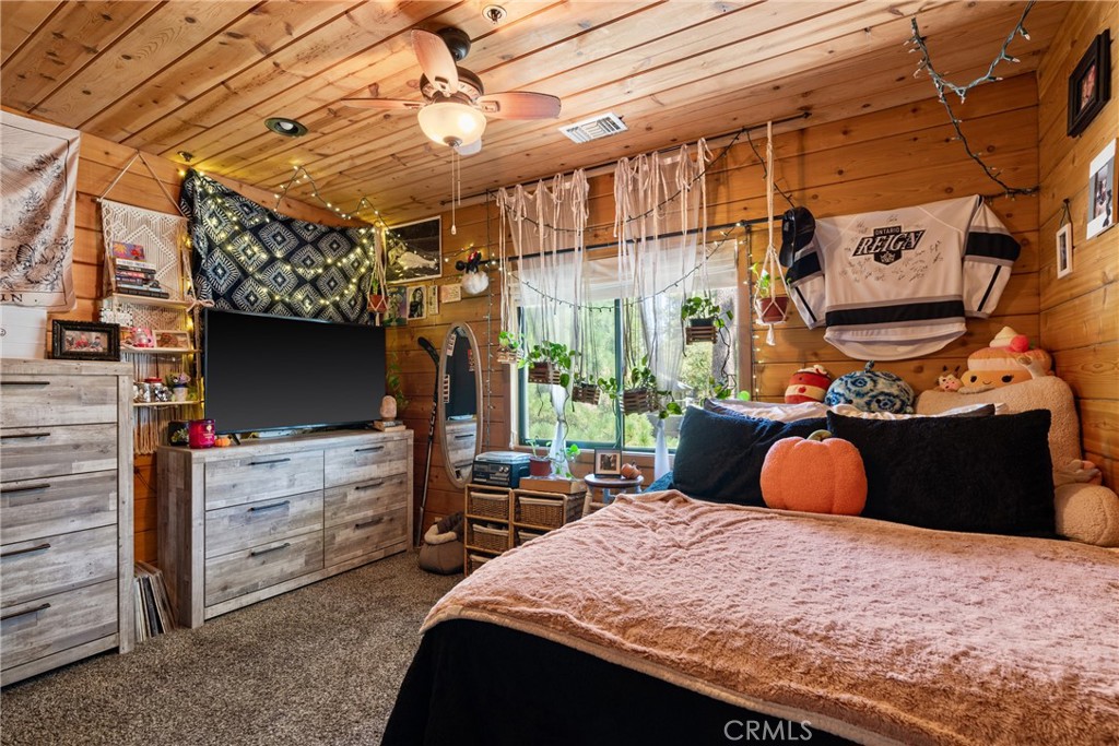 116 Pine Ridge Road Crestline, CA 92325 - Photo 22 of 35 a bedroom with bed and a chandelier