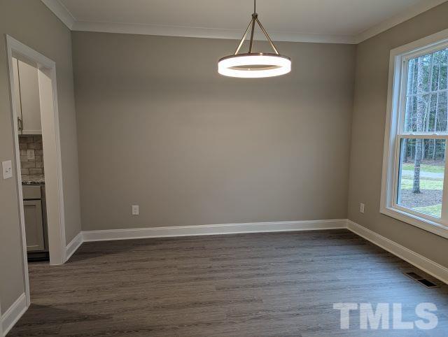 6237 Reagan Lane Wake Forest, NC 27587 - Photo 2 of 22 a view of an empty room with wooden floor and a window