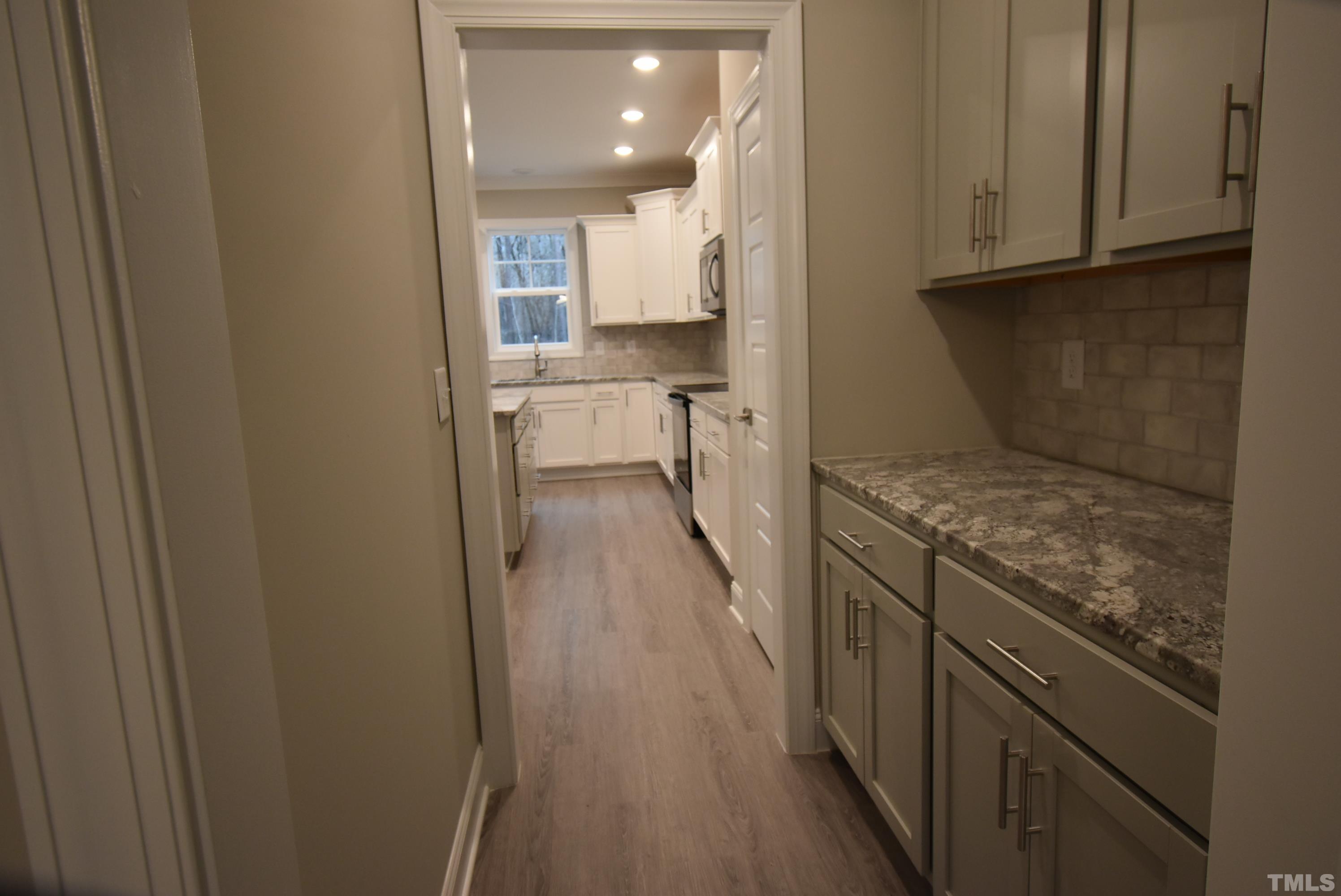 6237 Reagan Lane Wake Forest, NC 27587 - Photo 3 of 22 a view of a kitchen from the hallway