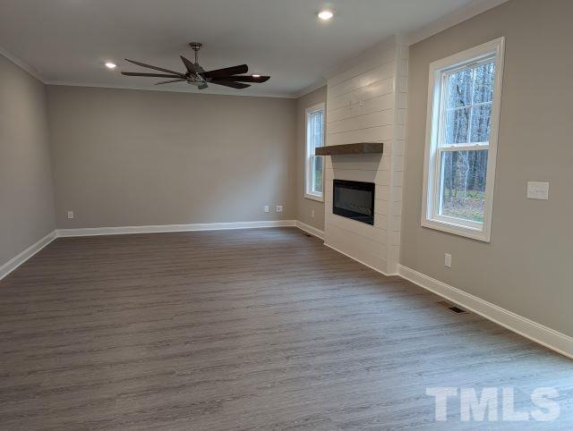 6237 Reagan Lane Wake Forest, NC 27587 - Photo 5 of 22 an empty room with wooden floor fireplace and windows