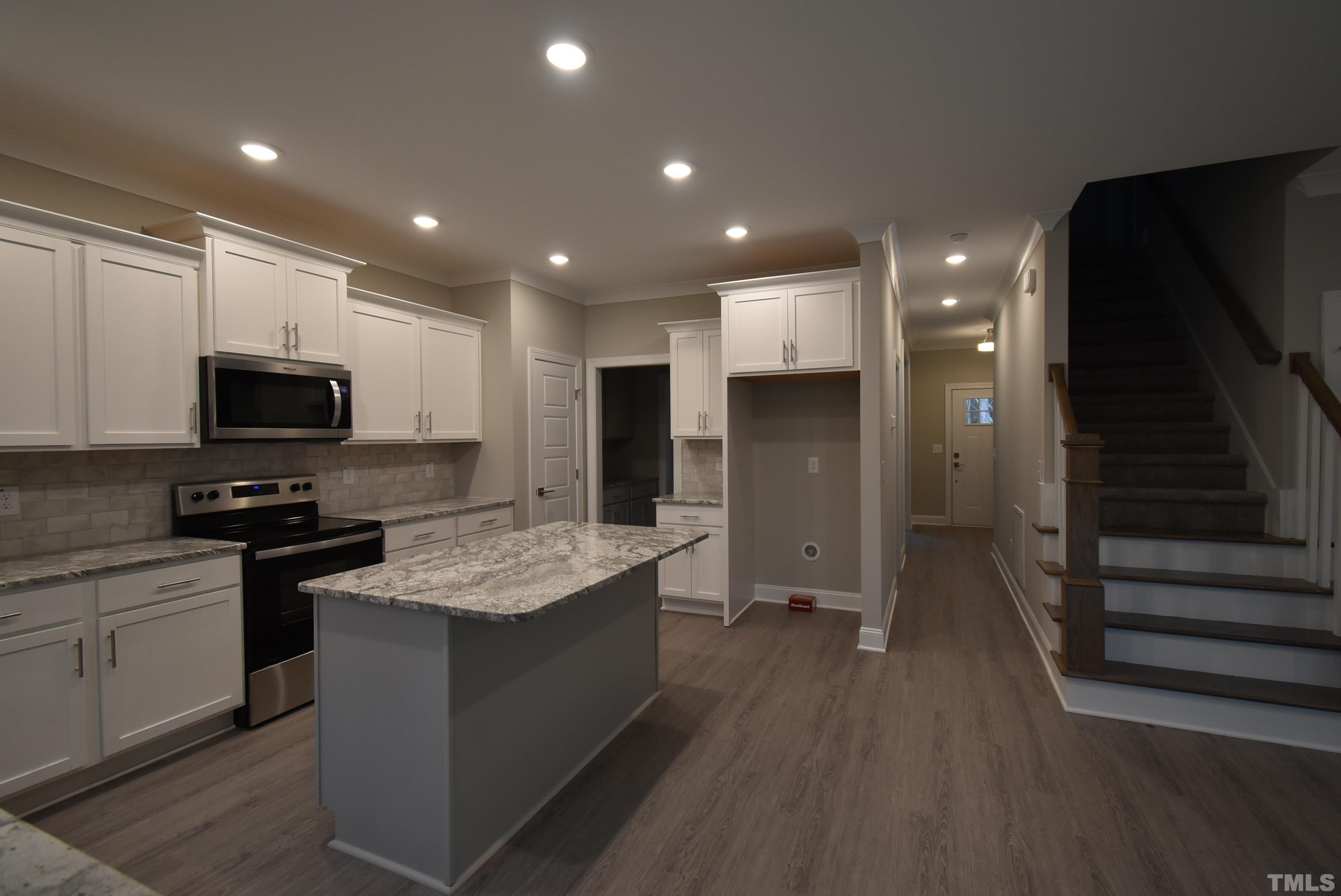 6237 Reagan Lane Wake Forest, NC 27587 - Photo 6 of 22 a kitchen with stainless steel appliances granite countertop a sink stove and refrigerator