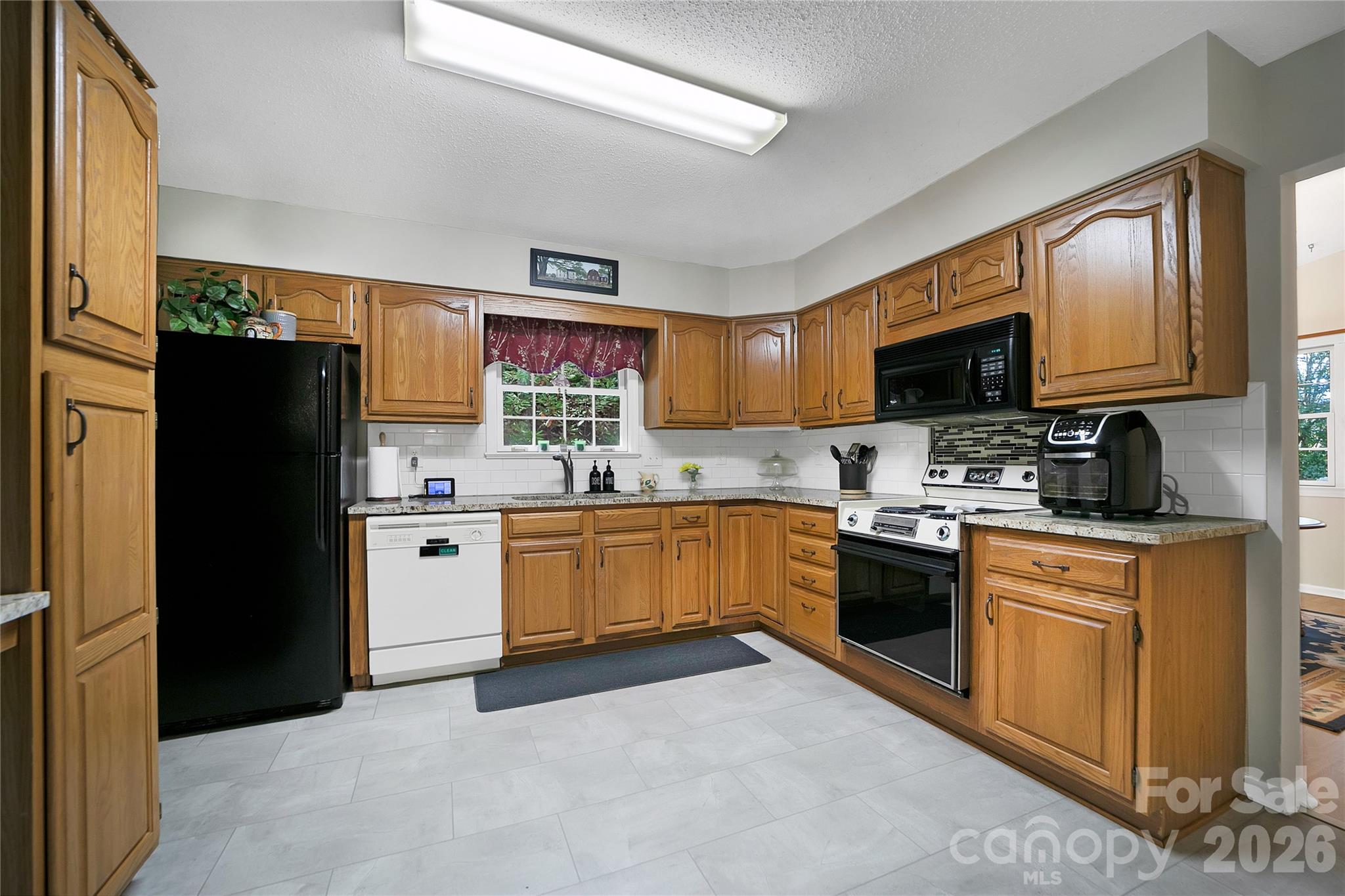 239 Three Mile Knob Road Pisgah Forest, NC 28768 - Photo 16 of 48 a kitchen with stainless steel appliances granite countertop a refrigerator stove and sink