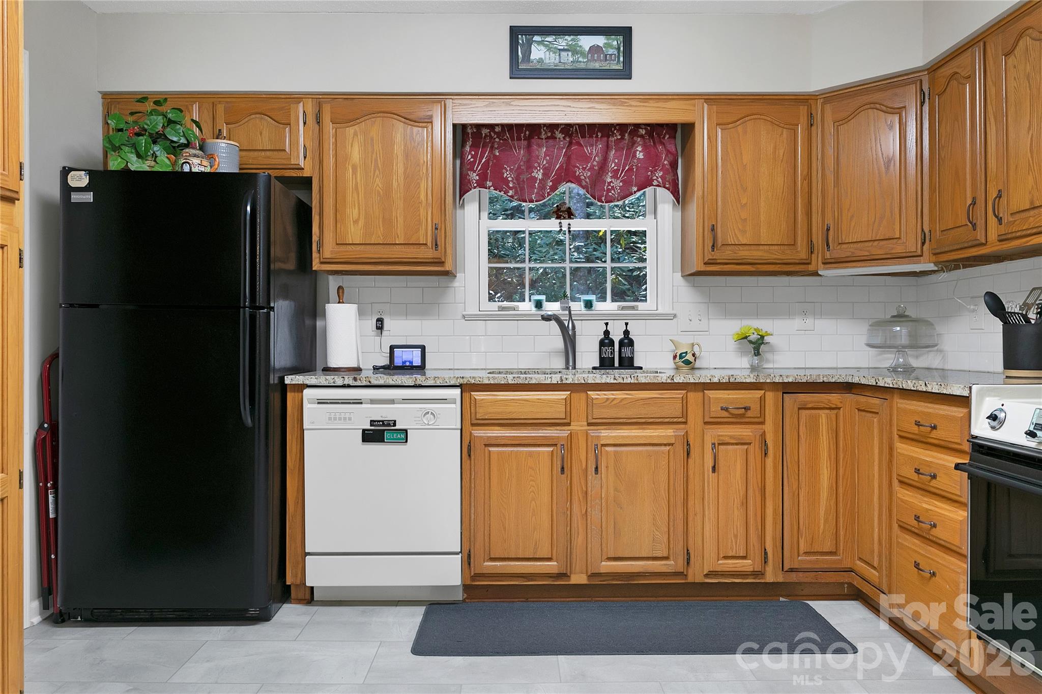 239 Three Mile Knob Road Pisgah Forest, NC 28768 - Photo 18 of 48 a kitchen with stainless steel appliances granite countertop a refrigerator stove and sink