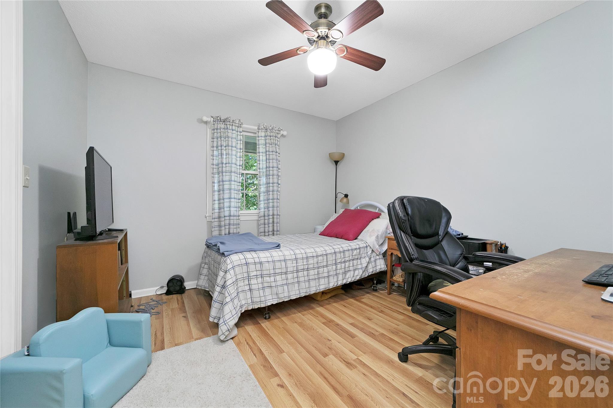 239 Three Mile Knob Road Pisgah Forest, NC 28768 - Photo 20 of 48 a bedroom with a bed and wooden floor