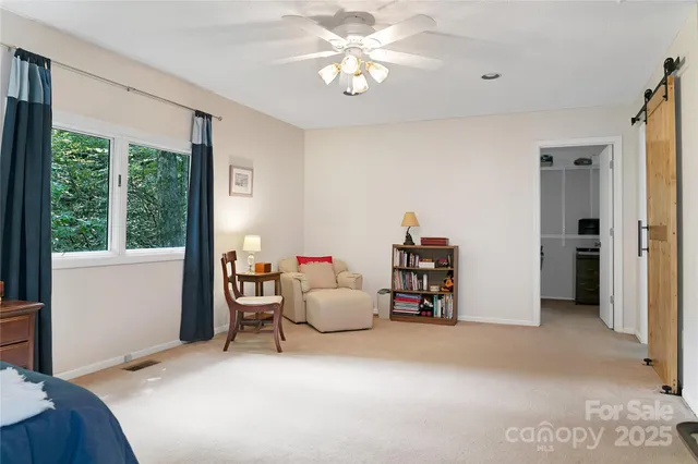 a living room with furniture and a chair