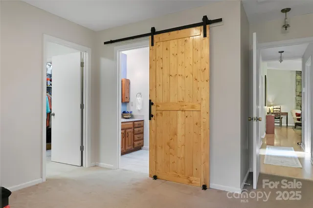 a spacious bathroom with a toilet a sink and a mirror