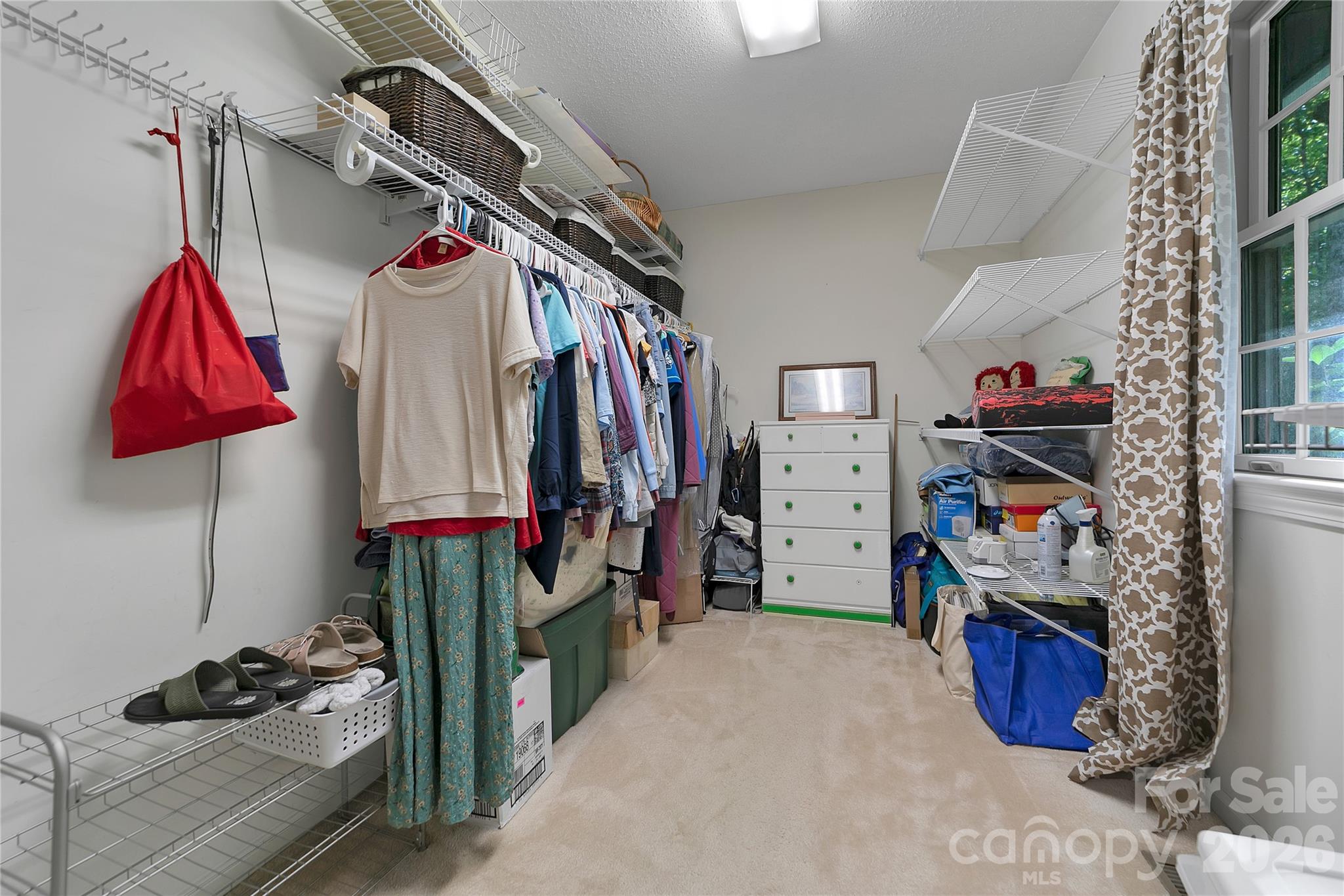 239 Three Mile Knob Road Pisgah Forest, NC 28768 - Photo 30 of 48 a view of walk in closet with clothes and shoes