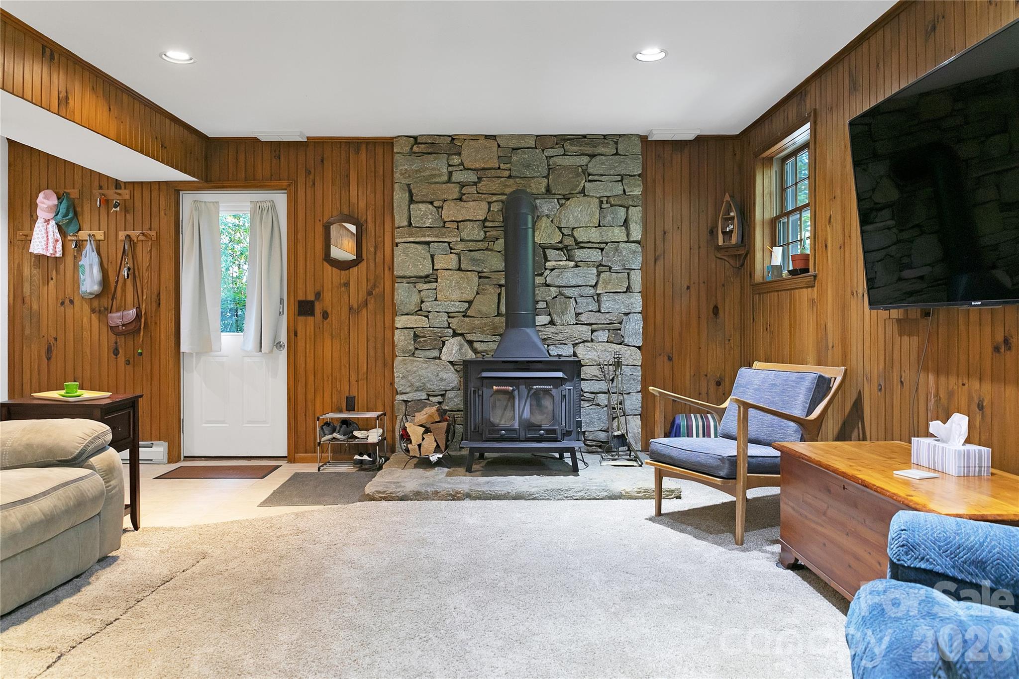239 Three Mile Knob Road Pisgah Forest, NC 28768 - Photo 37 of 48 a living room with furniture a flat screen tv and a fireplace
