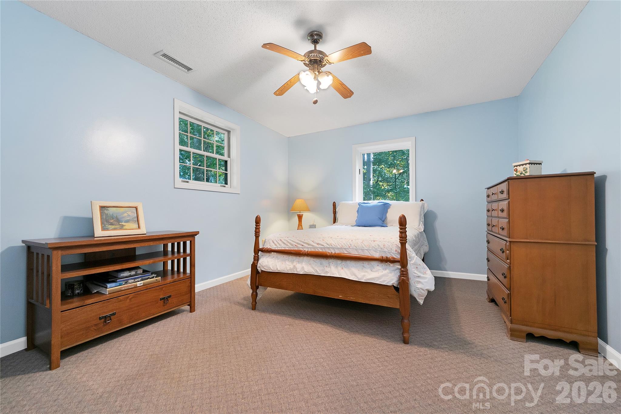 239 Three Mile Knob Road Pisgah Forest, NC 28768 - Photo 40 of 48 a bedroom with a bed and a ceiling fan