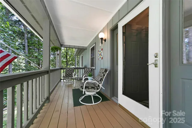 a view of a chair and tables in the balcony