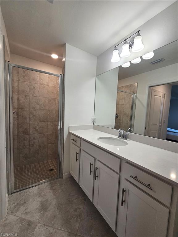 5835 Double Eagle Circle, Unit 4711 Immokalee, FL 34142 - Photo 11 of 44 a bathroom with a double vanity sink mirror and shower