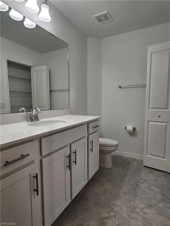 5835 Double Eagle Circle, Unit 4711 Immokalee, FL 34142 - Photo 12 of 44 a bathroom with a double vanity sink toilet and a mirror