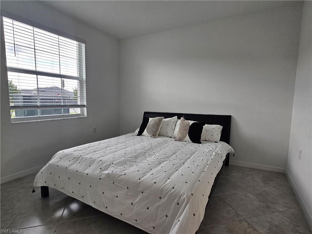 5835 Double Eagle Circle, Unit 4711 Immokalee, FL 34142 - Photo 13 of 44 a bedroom with a bed and window