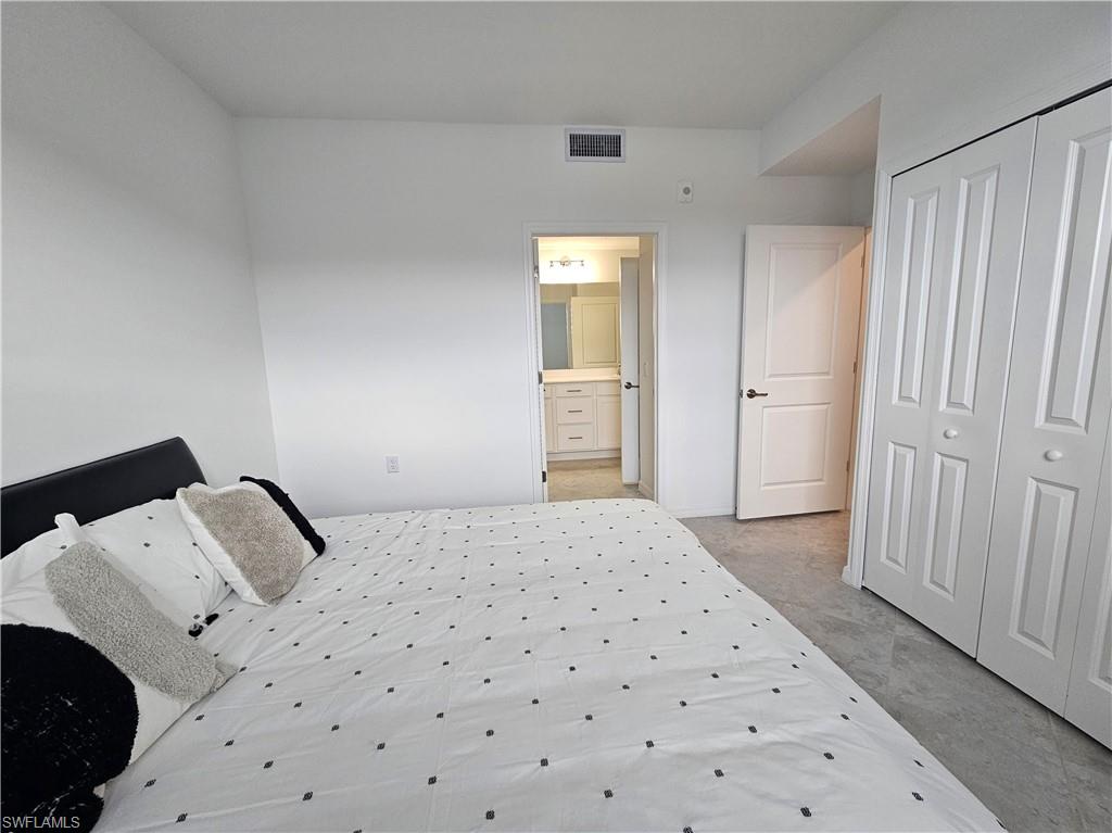 5835 Double Eagle Circle, Unit 4711 Immokalee, FL 34142 - Photo 14 of 44 a bedroom with a bed and a cabinets
