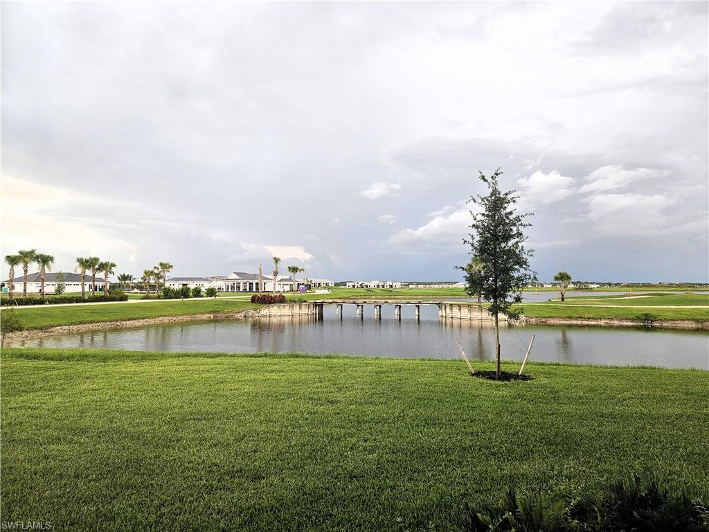 5835 Double Eagle Circle, Unit 4711 Immokalee, FL 34142 - Photo 24 of 44 a view of a lake with houses in the back