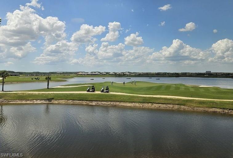 5835 Double Eagle Circle, Unit 4711 Immokalee, FL 34142 - Photo 27 of 44 a view of a lake with houses in the back