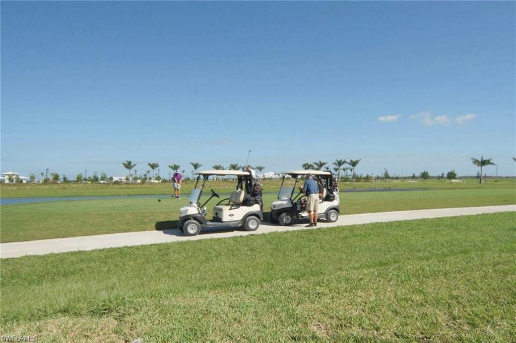 5835 Double Eagle Circle, Unit 4711 Immokalee, FL 34142 - Photo 28 of 44 a view of a golf course with chairs