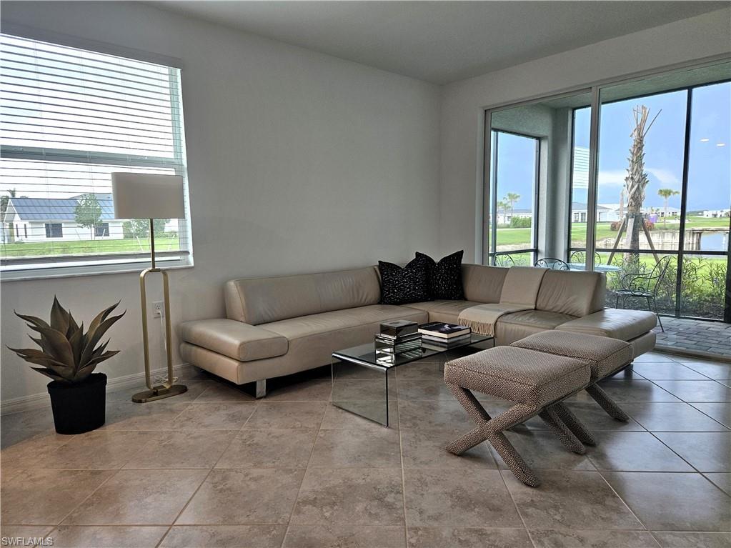 5835 Double Eagle Circle, Unit 4711 Immokalee, FL 34142 - Photo 3 of 44 a living room with furniture and a large window