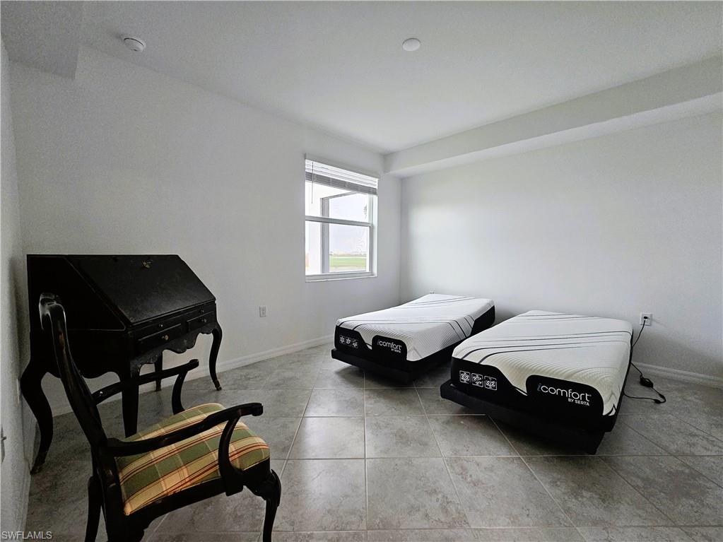 5835 Double Eagle Circle, Unit 4711 Immokalee, FL 34142 - Photo 8 of 44 a spacious bedroom with two beds and a window