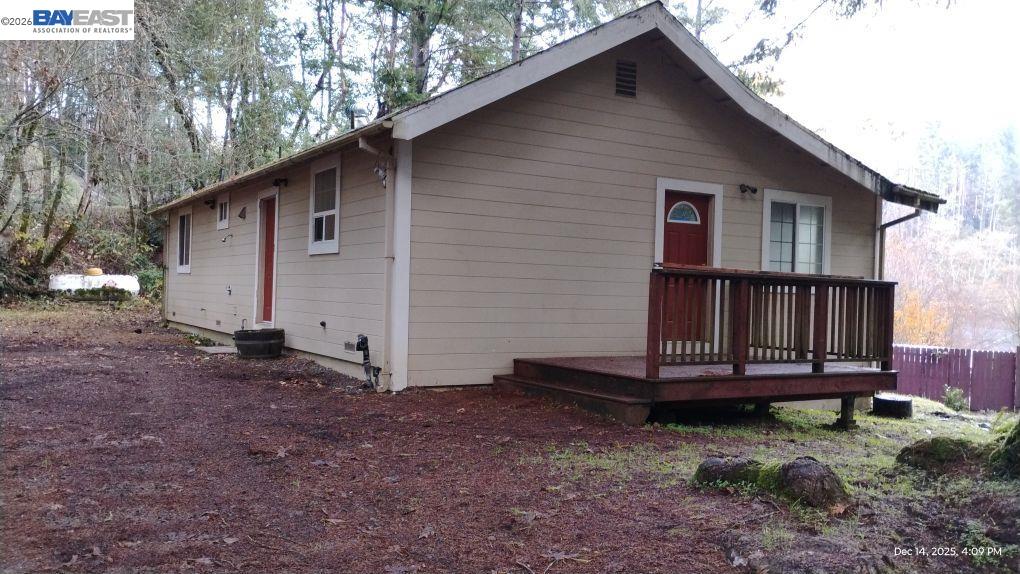a view of backyard with small cabin and wooden fence