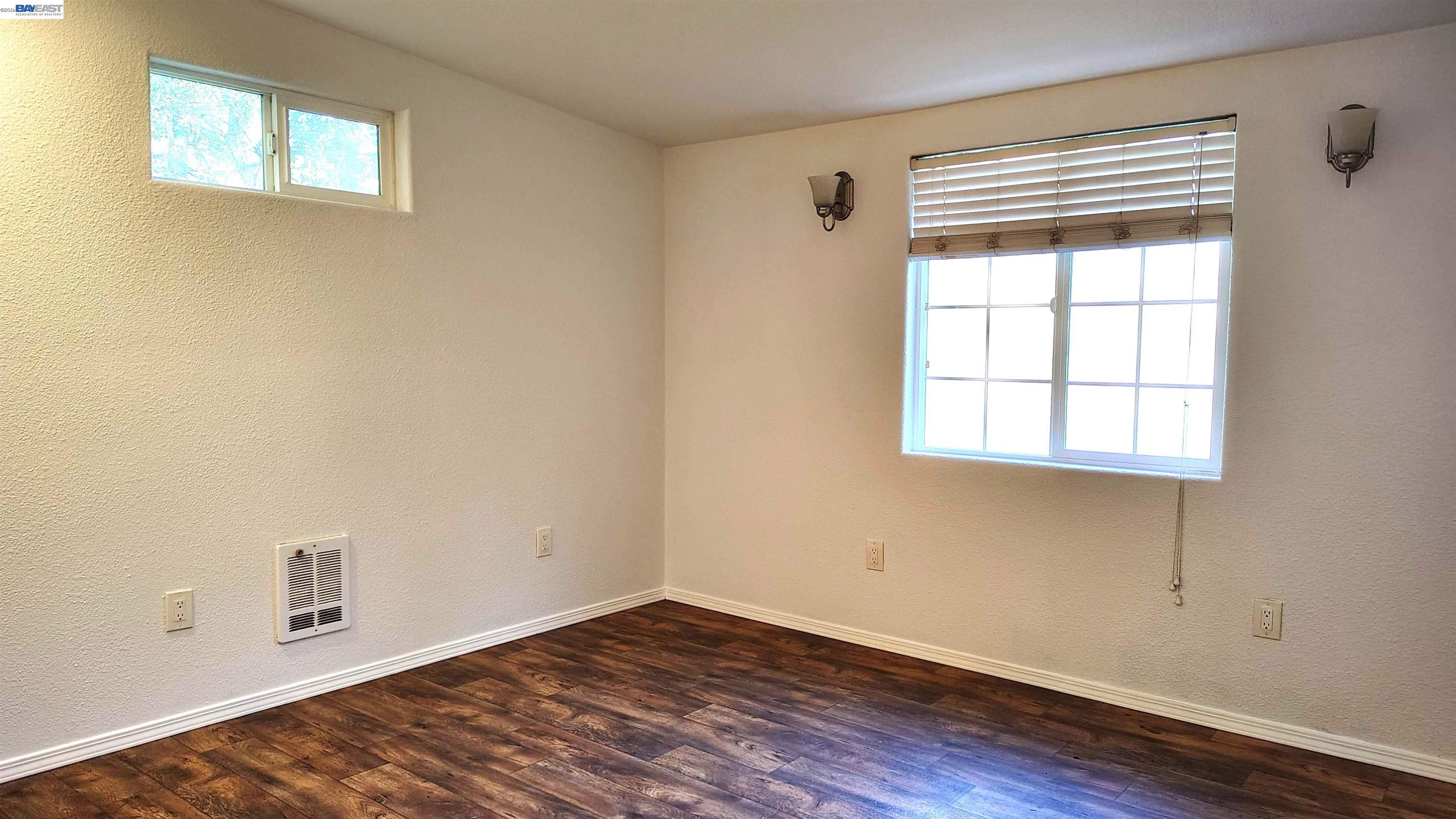 28440 Ryan Creek Road Willits, CA 95490 - Photo 14 of 22 an empty room with wooden floor and windows