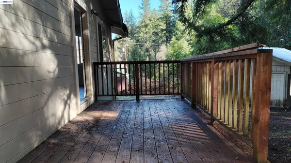 a view of a balcony with wooden floor