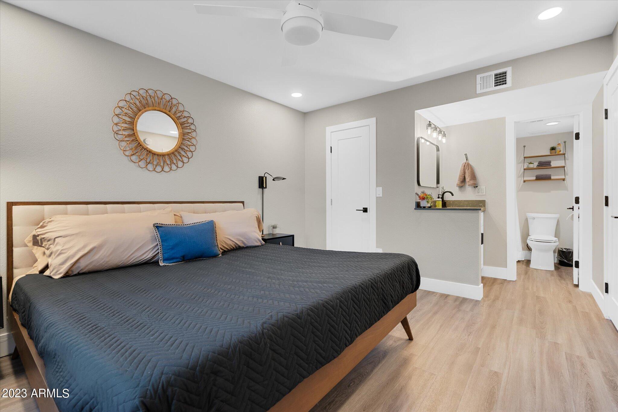 533 West Guadalupe Road, Unit 1024 Mesa, AZ 85210 - Photo 36 of 60 a bedroom with a bed and painting on the wall