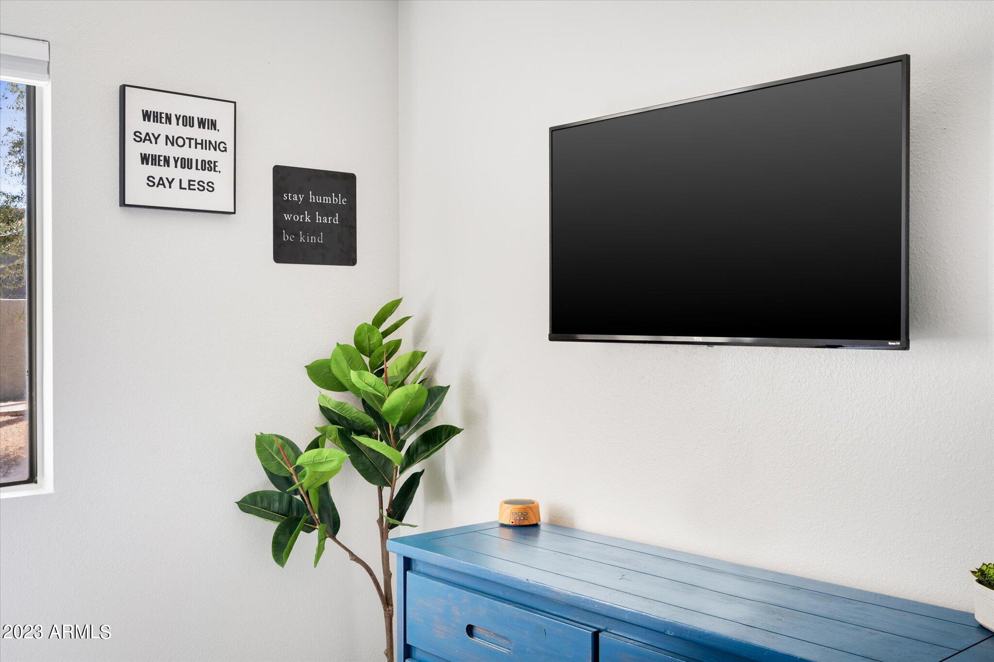 533 West Guadalupe Road, Unit 1024 Mesa, AZ 85210 - Photo 49 of 60 a view of a microwave with a potted plant on a wall