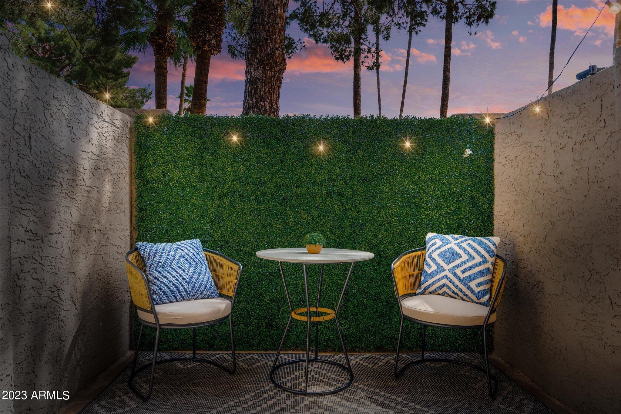 533 West Guadalupe Road, Unit 1024 Mesa, AZ 85210 - Photo 50 of 60 a view of a backyard with table and chairs potted plants and palm tree