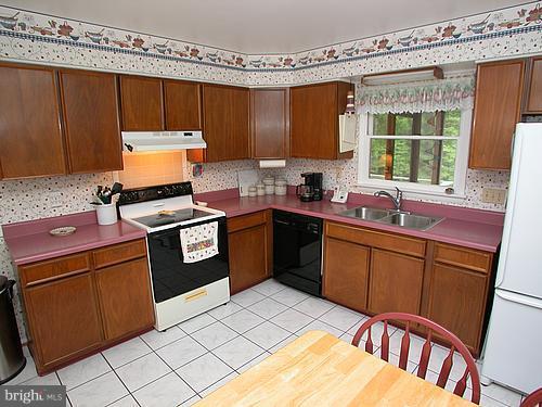 1902 Moore Road Forest Hill, MD 21050 - Photo 6 of 27 a kitchen with stainless steel appliances granite countertop a sink stove and refrigerator