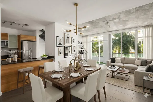 a dining room with furniture a chandelier and wooden floor