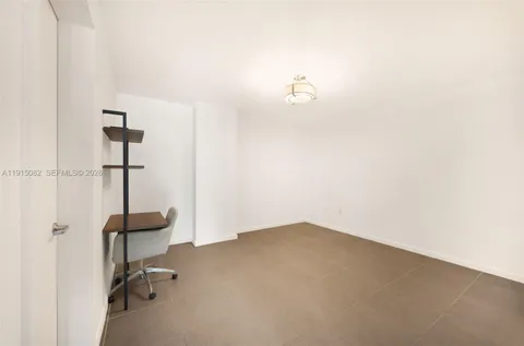 a view of walk in closet with clothes