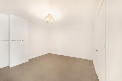 a row of palm trees and a building in the background