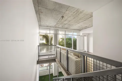 a view of a backyard with plants and palm tree
