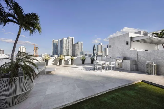 a view of a house with backyard and sitting area
