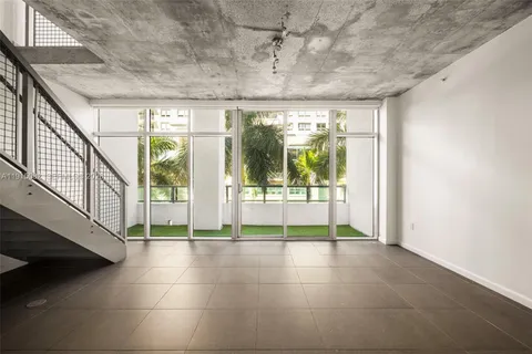 a kitchen with stainless steel appliances granite countertop a sink and a refrigerator